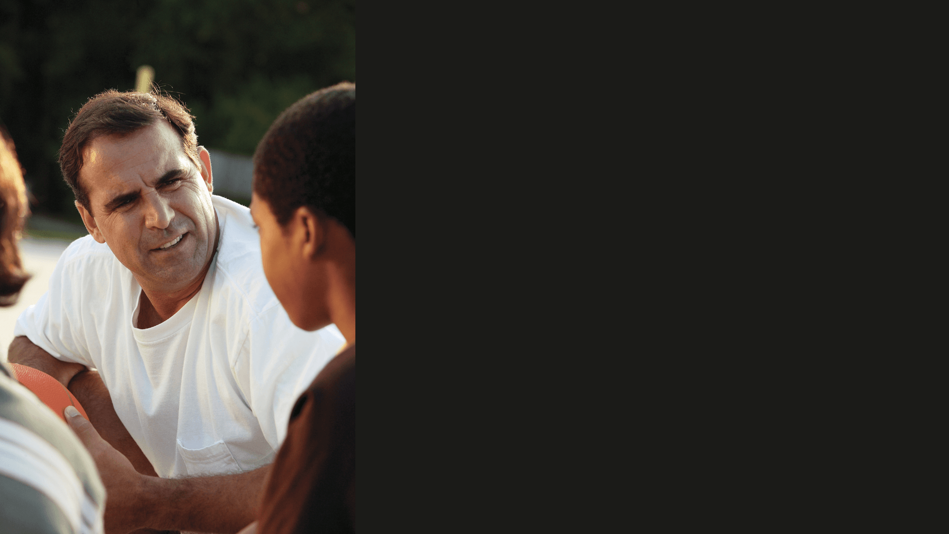 Young athlete sitting on basketball court